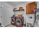 Functional laundry room with washer, dryer, storage cabinet, utility sink, and ample storage space at 500 Creek Valley Dr, Fuquay Varina, NC 27526