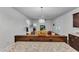 Open concept living room featuring hardwood floors, white trim, and access to a modern kitchen area at 500 Creek Valley Dr, Fuquay Varina, NC 27526