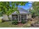 Cozy screened porch with seating and a view of the landscaped backyard and mature tree canopy at 500 Creek Valley Dr, Fuquay Varina, NC 27526