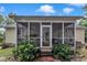 Back of home with screened porch and outdoor living space surrounded by lush plantings at 500 Creek Valley Dr, Fuquay Varina, NC 27526