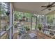 Bright screened-in porch features comfortable seating and a view of the garden at 500 Creek Valley Dr, Fuquay Varina, NC 27526
