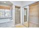 Bathroom with a tiled shower, soaking tub, and sliding mirrored doors to the walk-in closet at 5460 Ingate Way, Raleigh, NC 27613