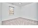 Bright bedroom featuring plush carpet and a double window allowing natural light to enter at 5460 Ingate Way, Raleigh, NC 27613