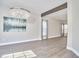 Open dining space with modern chandelier, wood beam and luxury vinyl plank flooring at 5460 Ingate Way, Raleigh, NC 27613