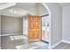 Bright foyer with wood-look floors, open doorways, and neutral paint at 5460 Ingate Way, Raleigh, NC 27613