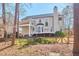 Spacious backyard view featuring a covered patio, chimney, and manicured lawn, perfect for outdoor living at 5460 Ingate Way, Raleigh, NC 27613