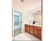 Bright bathroom features double sinks and an open doorway to a linen closet at 5841 Wynmore Rd, Raleigh, NC 27610
