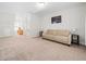Open bonus room features neutral carpet, beige sofa, and decor on the walls at 5841 Wynmore Rd, Raleigh, NC 27610
