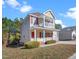 Tan home featuring a welcoming front porch with white railing and two stories at 5841 Wynmore Rd, Raleigh, NC 27610