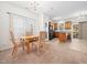 Open-concept kitchen and dining area with wood cabinets, granite countertops, and ample natural light at 5841 Wynmore Rd, Raleigh, NC 27610
