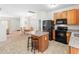Modern kitchen featuring a center island with seating, stainless steel appliances, and stylish countertops at 5841 Wynmore Rd, Raleigh, NC 27610