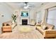 Cozy living room featuring a fireplace, neutral color palette, and comfortable sofas at 5841 Wynmore Rd, Raleigh, NC 27610