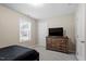 Simple bedroom has a bed, a window for light, and a dresser for storage at 5976 Jones Farm Rd, Wake Forest, NC 27587