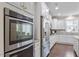 Modern kitchen with stainless steel appliances, white cabinetry and granite countertops at 5976 Jones Farm Rd, Wake Forest, NC 27587