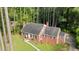 An elevated view of a brick home showing landscaping, mature trees, and a well-maintained lawn at 612 W Chisholm St, Sanford, NC 27330