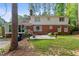 Spacious backyard showing a two-story brick home with a large patio and green lawn at 612 W Chisholm St, Sanford, NC 27330