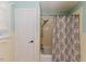 A standard bathtub and shower feature a paisley pattern shower curtain at 612 W Chisholm St, Sanford, NC 27330