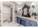 Charming bathroom showcasing vintage-style fixtures, blue floral wallpaper, and hexagonal tile flooring at 612 W Chisholm St, Sanford, NC 27330