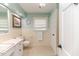 Bright bathroom with a white vanity, toilet, and cream-colored tile, showcasing a clean and classic design at 612 W Chisholm St, Sanford, NC 27330