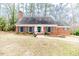 Lovely single-story red brick home featuring a well-maintained lawn and classic architectural details at 612 W Chisholm St, Sanford, NC 27330