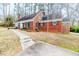 Side view of brick house showcasing the driveway, multiple windows, and classic architecture at 612 W Chisholm St, Sanford, NC 27330