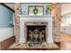 Detailed fireplace features a brick surround, stone hearth, and custom mantle at 612 W Chisholm St, Sanford, NC 27330