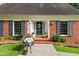 A classic brick facade with black shutters and a welcoming wreath on the front door at 612 W Chisholm St, Sanford, NC 27330