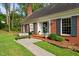 Inviting front porch featuring brick steps, an outdoor bench, and decorative plants and wreath at 612 W Chisholm St, Sanford, NC 27330