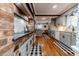 Bright kitchen with stainless steel appliances, stone countertops, and hardwood floors at 612 W Chisholm St, Sanford, NC 27330
