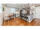 Kitchen featuring an island with barstool seating, stainless appliances, and wood floors at 612 W Chisholm St, Sanford, NC 27330