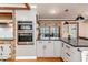Bright kitchen features stainless steel appliances, granite countertops, and hardwood floors at 612 W Chisholm St, Sanford, NC 27330