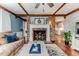 Cozy living room with brick fireplace, exposed beams, and hardwood floors at 612 W Chisholm St, Sanford, NC 27330