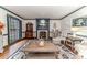 Living room featuring a fireplace, area rug, hardwood floors, and lots of natural light at 612 W Chisholm St, Sanford, NC 27330