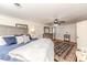 Cozy main bedroom features a ceiling fan, neutral walls, and a comfortable bed with blue accents at 612 W Chisholm St, Sanford, NC 27330