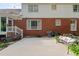 Patio with concrete, showing the two-story brick home with white siding and mature landscaping at 612 W Chisholm St, Sanford, NC 27330