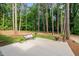 Concrete patio set in a backyard, with room for seating and potted plants amid mature trees at 612 W Chisholm St, Sanford, NC 27330