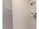 This shower features white tile, a chrome shower head, and a frosted glass shower door at 612 W Chisholm St, Sanford, NC 27330