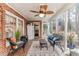 Bright sunroom with brick walls and lots of windows, furnished with wicker furniture and plants at 612 W Chisholm St, Sanford, NC 27330
