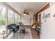 Charming sunroom with comfortable seating, brick accents, ceiling fan, and an abundance of light at 612 W Chisholm St, Sanford, NC 27330