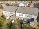 Aerial view of townhomes with well-maintained yards and a community pond, offering a serene living environment at 626 Denhoff Dr, Cary, NC 27519