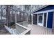 A spacious back deck with a gray wood railing and steps leading to the back yard and a screened-in porch at 6317 Lakeland Dr, Raleigh, NC 27612