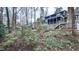 A view of the backyard with landscaping leading up to the deck, screened-in porch, and backyard of the home at 6317 Lakeland Dr, Raleigh, NC 27612