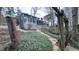 Backyard features a screened-in porch, mature trees, and stone pathway at 6317 Lakeland Dr, Raleigh, NC 27612