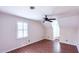 Bright bedroom features hardwood floors, window shutters, and a modern ceiling fan at 6317 Lakeland Dr, Raleigh, NC 27612