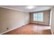 This bedroom features a window with plantation shutters and a neutral color palette at 6317 Lakeland Dr, Raleigh, NC 27612