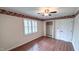 Charming bedroom features hardwood floors, window shutters, and decorative floral trim at 6317 Lakeland Dr, Raleigh, NC 27612