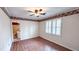 Bright bedroom features hardwood floors, window shutters, and direct access to the bathroom at 6317 Lakeland Dr, Raleigh, NC 27612