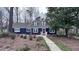 Classic blue home featuring a well-manicured lawn, walkway, and carefully selected shrubbery in a tranquil setting at 6317 Lakeland Dr, Raleigh, NC 27612