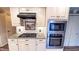This kitchen includes stainless steel appliances, a black range hood, granite counters and custom cabinets and drawers at 6317 Lakeland Dr, Raleigh, NC 27612