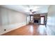 Spacious living room with wood floors, brick fireplace, and ceiling fan at 6317 Lakeland Dr, Raleigh, NC 27612